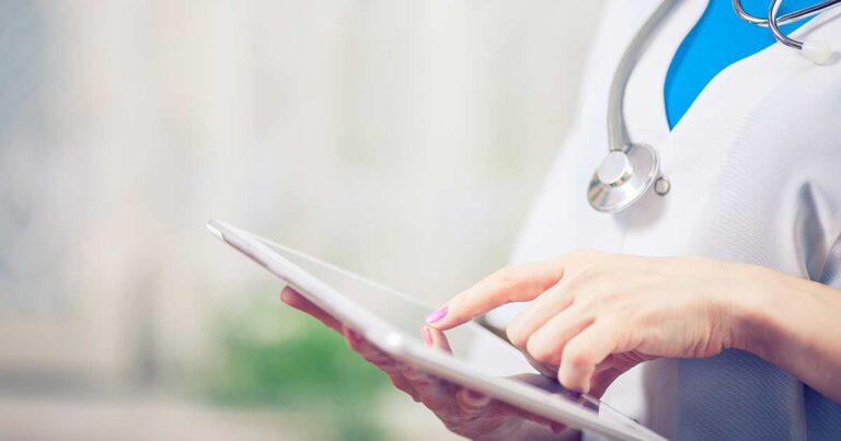 A nurse doing her continuing education units on an ipad.