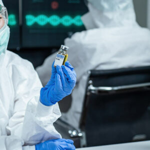 Image of nurse reading the Covid-19 vaccine vile